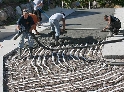 Heat cable in mats being installed for radiant driveway heating.