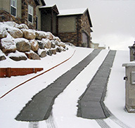 A steep driveway with heated tire tracks.